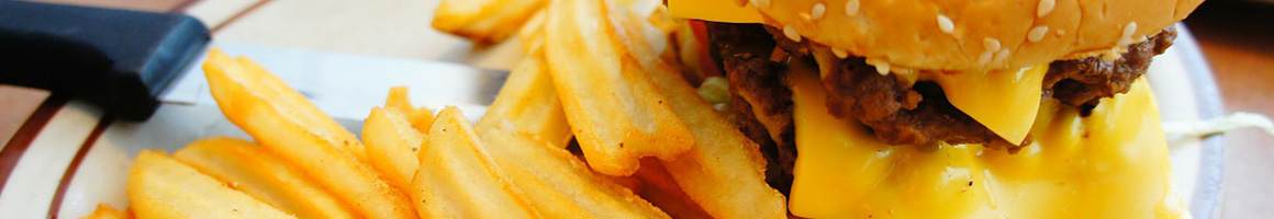 Eating American (Traditional) Burger at Grub's Drive-In restaurant in Rock Springs, WY.